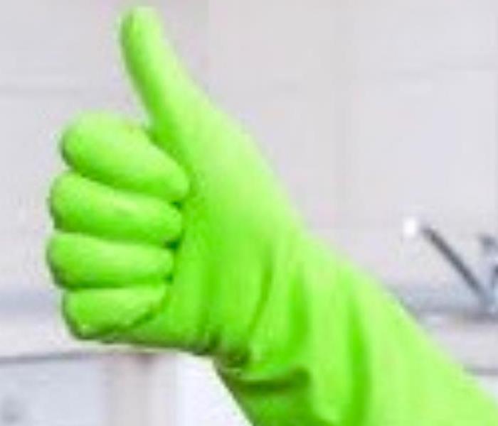 Rubber glove with a thumbs up gesture