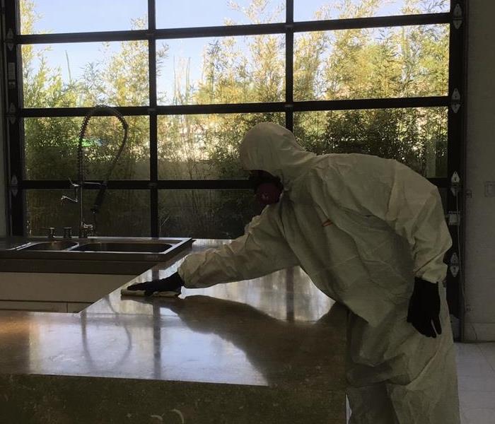 SERVPRO of Centennial Hills employee disinfecting counter top
